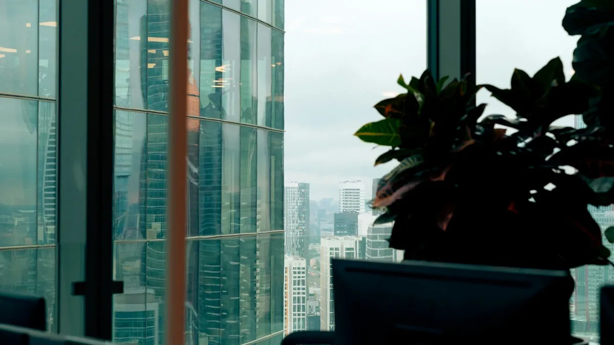 An office window looking out over a city skyline